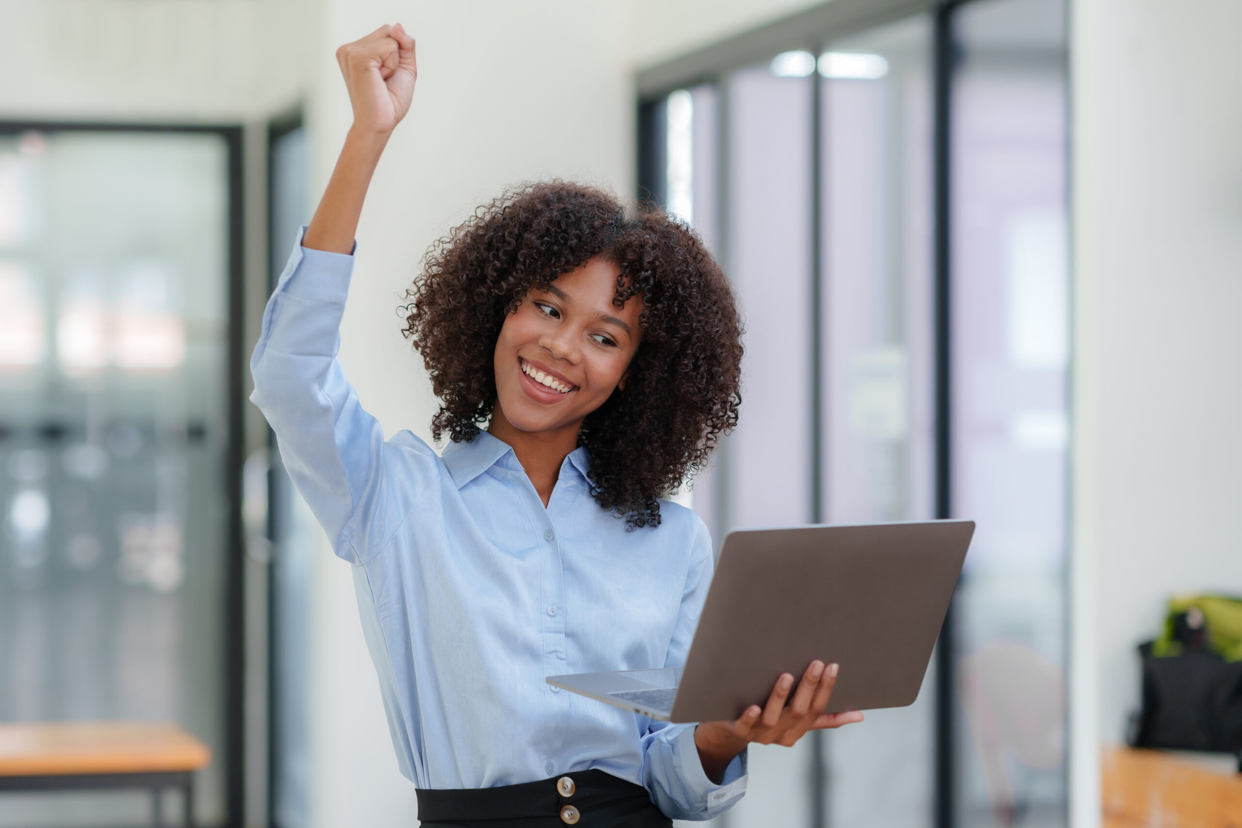 Businesswoman raising her hand in congratulation with document a